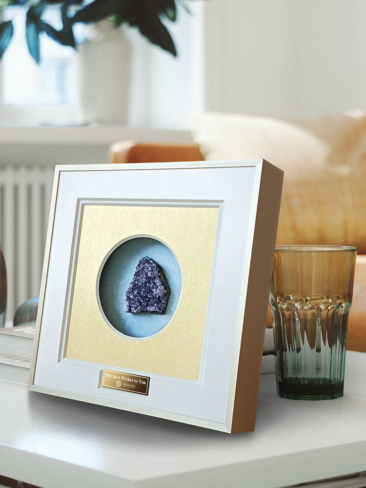 Close-up of genuine amethyst geode inside crystal display case with acrylic panel